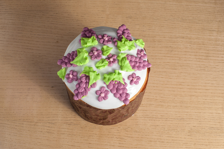 Decoration of baked easter paska bakery at wooden table from up