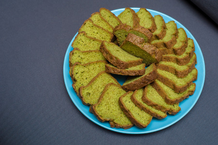 Holiday baked kulich pie with sweet decoration on black background