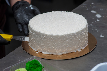 Covering pie in white coating at kitchen with lattice