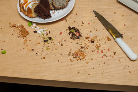 Fragment of baked pie in plate and chits with a knife