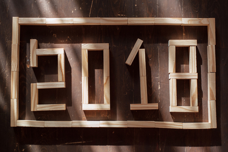Business and design concept - surreal abstract geometric floating wooden cube with word  2019 & 2018...