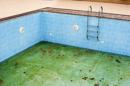 Top view of swim pool with little dirty water at bottomの写真素材