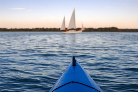 Bow of river kayak at sunset pointed at Dnepr Ukraineの写真素材
