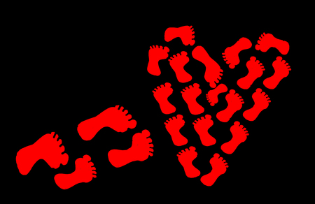 heart of human footprints on a black background.の写真素材