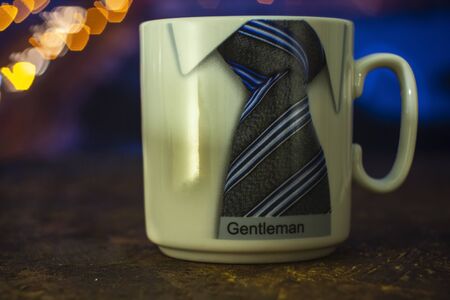 mug with a picture on the background of colorful bokeh.Behind the mug is a blurred background.Close-up mug with a pattern.のeditorial素材