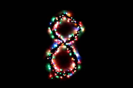 created figure 8 from a colorful bokeh on a black background.International women's day.March 8.の写真素材