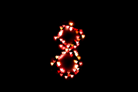 created figure 8 from a colorful bokeh on a black background.International women's day.March 8.の写真素材