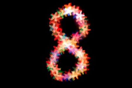 created figure 8 from a colorful bokeh on a black background.International women's day.March 8.の写真素材