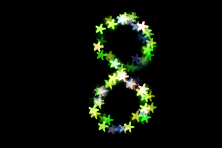 created figure 8 from a colorful bokeh on a black background.International women's day.March 8.の写真素材