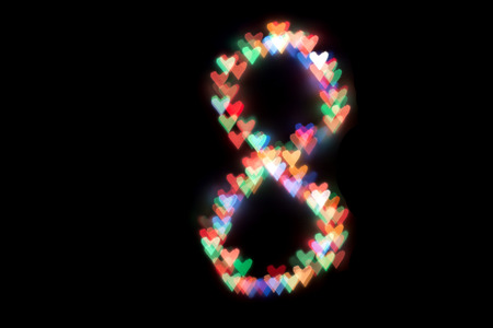 created figure 8 from a colorful bokeh on a black background.International women's day.March 8.の写真素材