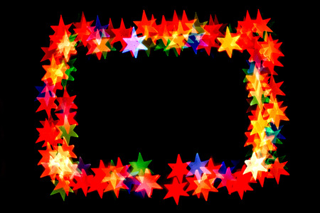 colorful stars form a frame.bokeh stars isolated on black background.frame of stars.の写真素材