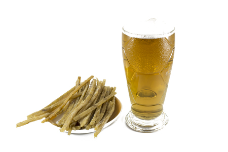on a white background, there are sliced fish strips and a beer mug with beer and foam.の写真素材