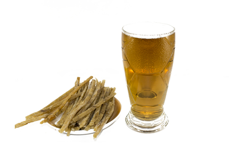 on a white background, there are sliced fish strips and a beer mug with beer and foam.の写真素材