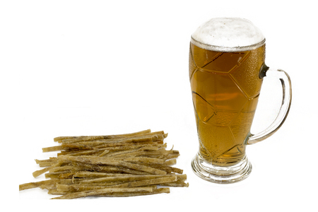 on a white background, there are sliced fish strips and a beer mug with beer and foam.の写真素材