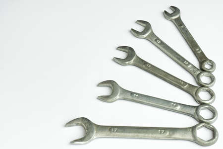 Five different wrenches lie on the right on a white backgroundの写真素材