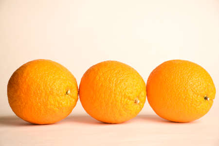 Three large oranges lie in a row on a white backgroundの写真素材