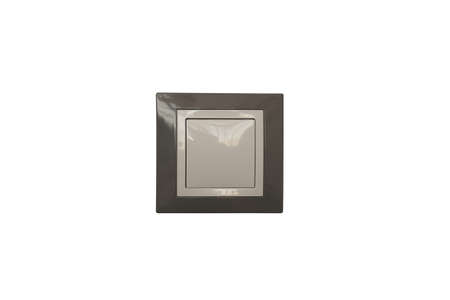 A plastic room light switch of a square shape in gray and white in the center of the frame on a...