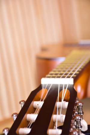 Close-up of an acoustic guitar lies on its side. Perspective frame with highly blurred backgroundの写真素材