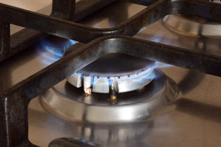 Kitchen gas stove with burning hot blue flame burner
