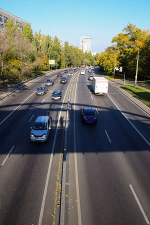Many cars are photographed from above from a high angle. Cars travel in different directions on a...