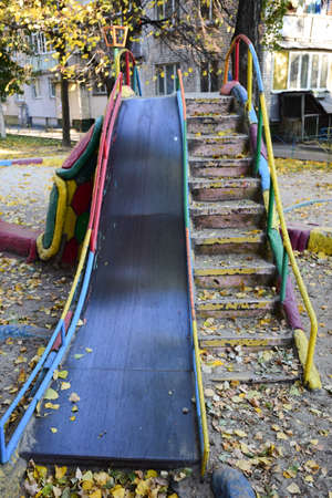 Large childrens slide for skating made of iron and concrete with a descent and a ladder