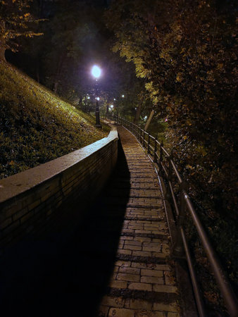 Spiral stone pavement in perspective at night on the mountain. Illuminated by a street lampの写真素材