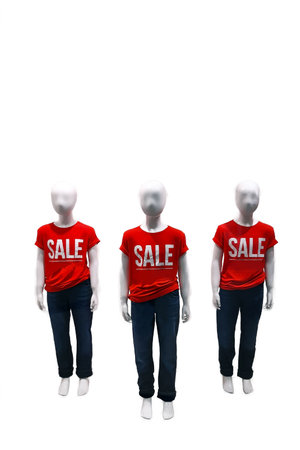 Three children's mannequins in red t-shirts with the inscription SALE on a white background with clipping pathの写真素材