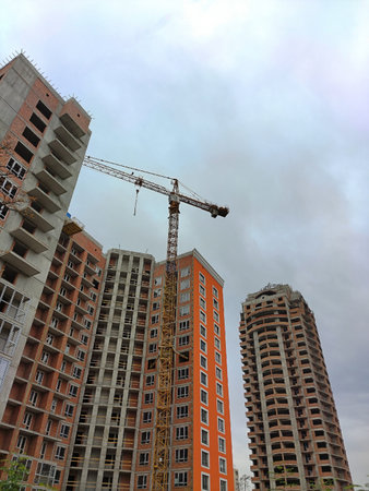 A tower crane near several high-rise buildings under construction