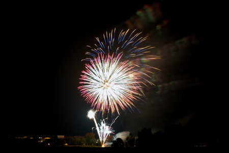 Sparkling explosions of fireworks and fireworks, isolated and blurred on black night background, design element for backgroundの写真素材