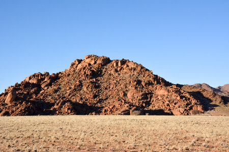 Stone peak on the hill against the background of the blue sky. Tourist destinations and natural landscapeの写真素材