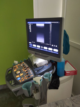 An ultrasound measuring device with a monitor is turned on in a medical office in a hospital....