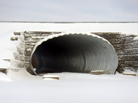 Entrance to an oval tunnel under the road. An example of an architectural solution for crossing to...