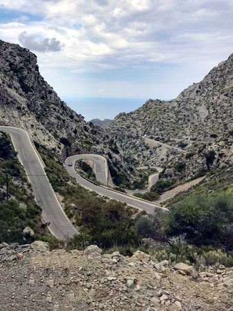 Serpentine winding road in the gorge between the mountains. Top view. Tourist natural landscapeの写真素材