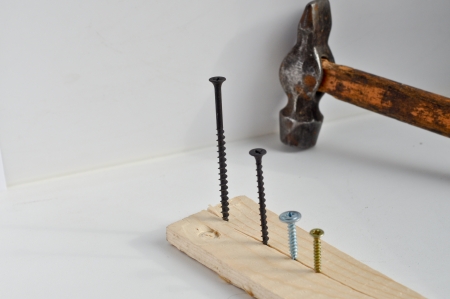 Screws and a hammer. The force is - do not mind!の写真素材