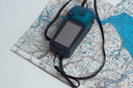 The Navigator with the cord lies on the topographic map 
