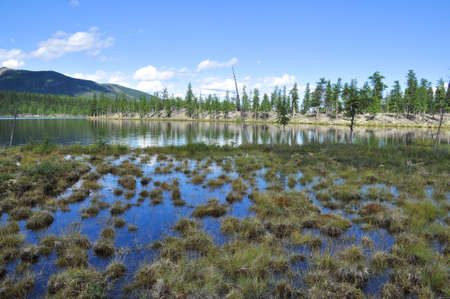 Eastern Yakutia. Summer landscape with a lake and mountains along the banks.