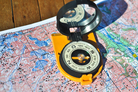 Compass and map. The magnetic compass is located on the topographic map.