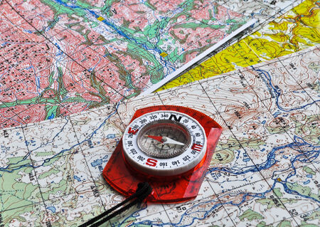 Map and compass. The magnetic compass is located on a topographic map.の写真素材