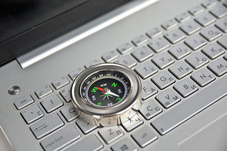 Navigation on the Internet! Photo of magnetic compass on computer keyboard.の写真素材