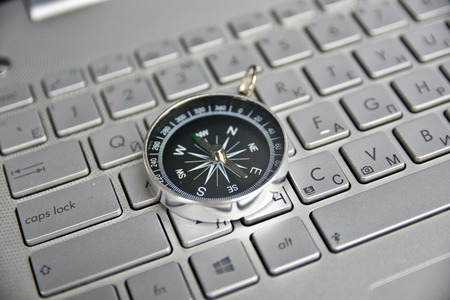 Navigation on the Internet! Photo of magnetic compass on computer keyboard.の写真素材