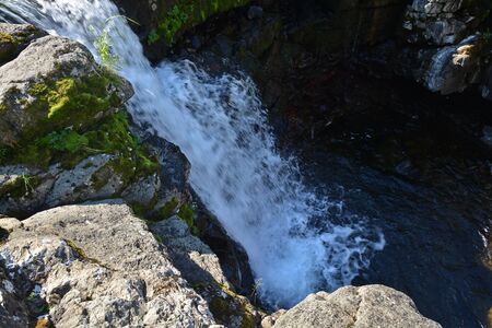 Waterfall on the Putorana plateau. Summer mountain landscape, decorated by a waterfall.