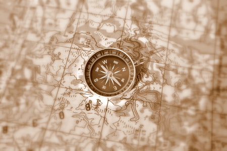 Tools for the journey - a map and a compass. Magnetic compass is located on a topographic map.の写真素材