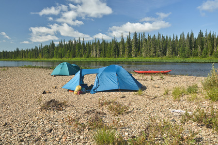 Kayak and tent on the river Bank. Parking travelers along the national Park Yugyd VA.の写真素材