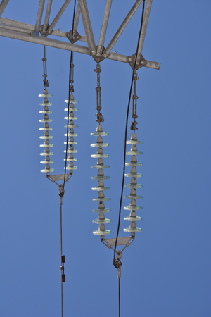 Insulators power lines. Photo of power lines against the blue sky.