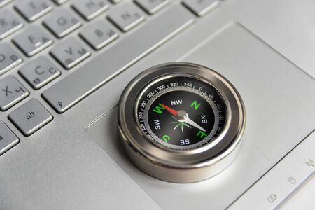 Compass on the keyboard. Search for information in the network.の写真素材