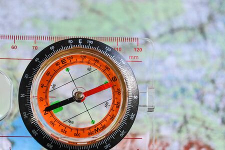 Going on a trip! Compass on the background of a topographic map.の写真素材