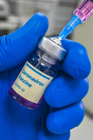 COVID-19 coronavirus vaccine trials. Vaccine bottle and label.の写真素材