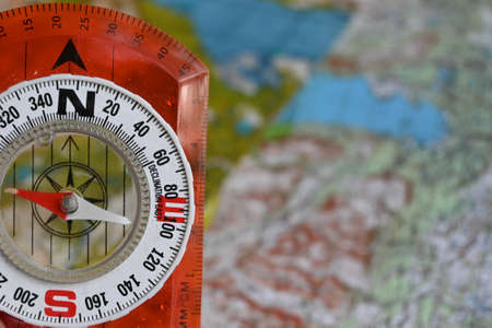 Compass and map. Compass on the background of a topographic map.の写真素材