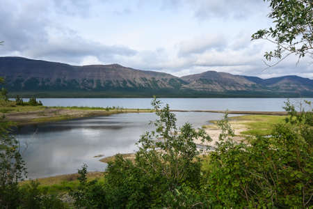 A mountain lake on the Putorana plateau. Water landscape in the region of active tourism in Russia.の写真素材