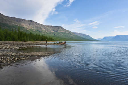 A mountain lake on the Putorana plateau. Water landscape in the region of active tourism in Russia.の写真素材